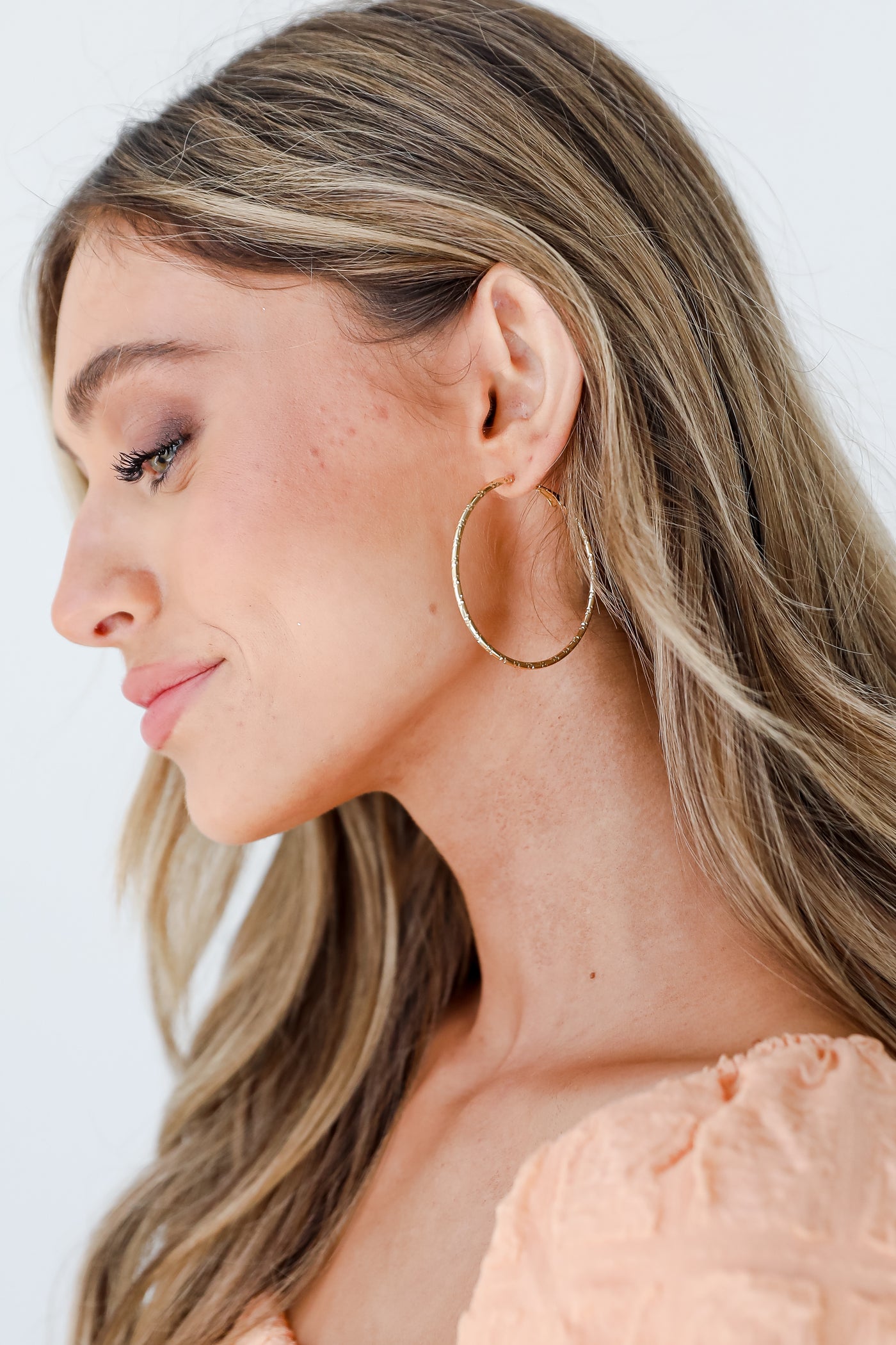 Gold Textured Hoop Earrings on model