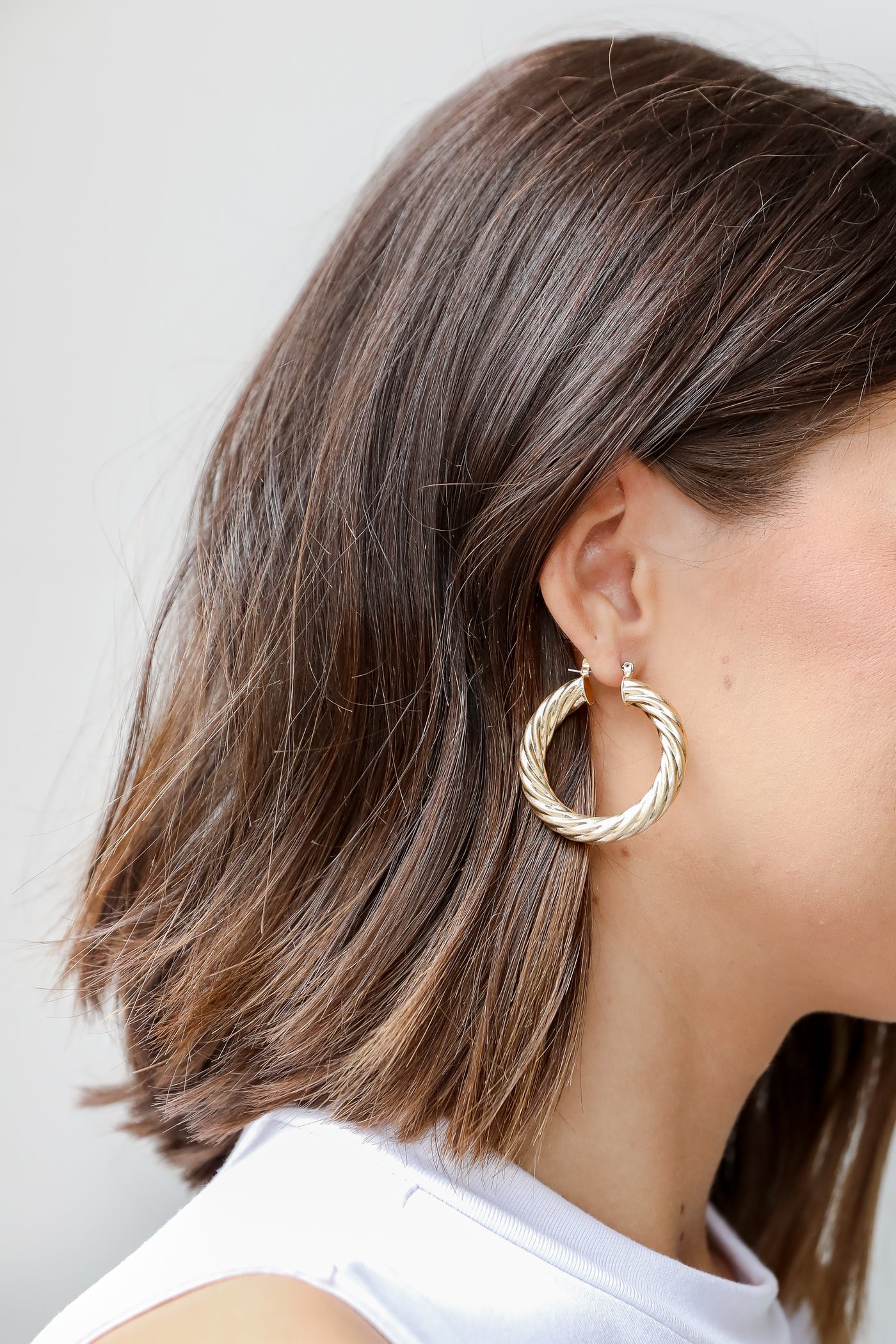 Gold Twisted Hoop Earrings on model