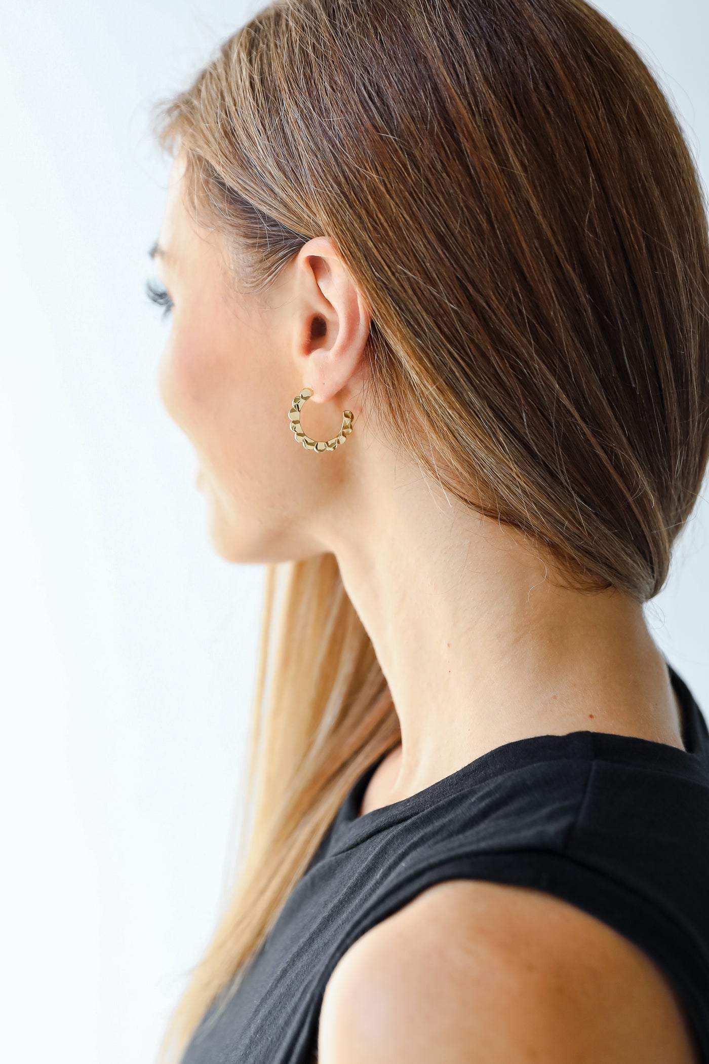 model wearing gold hoop earrings