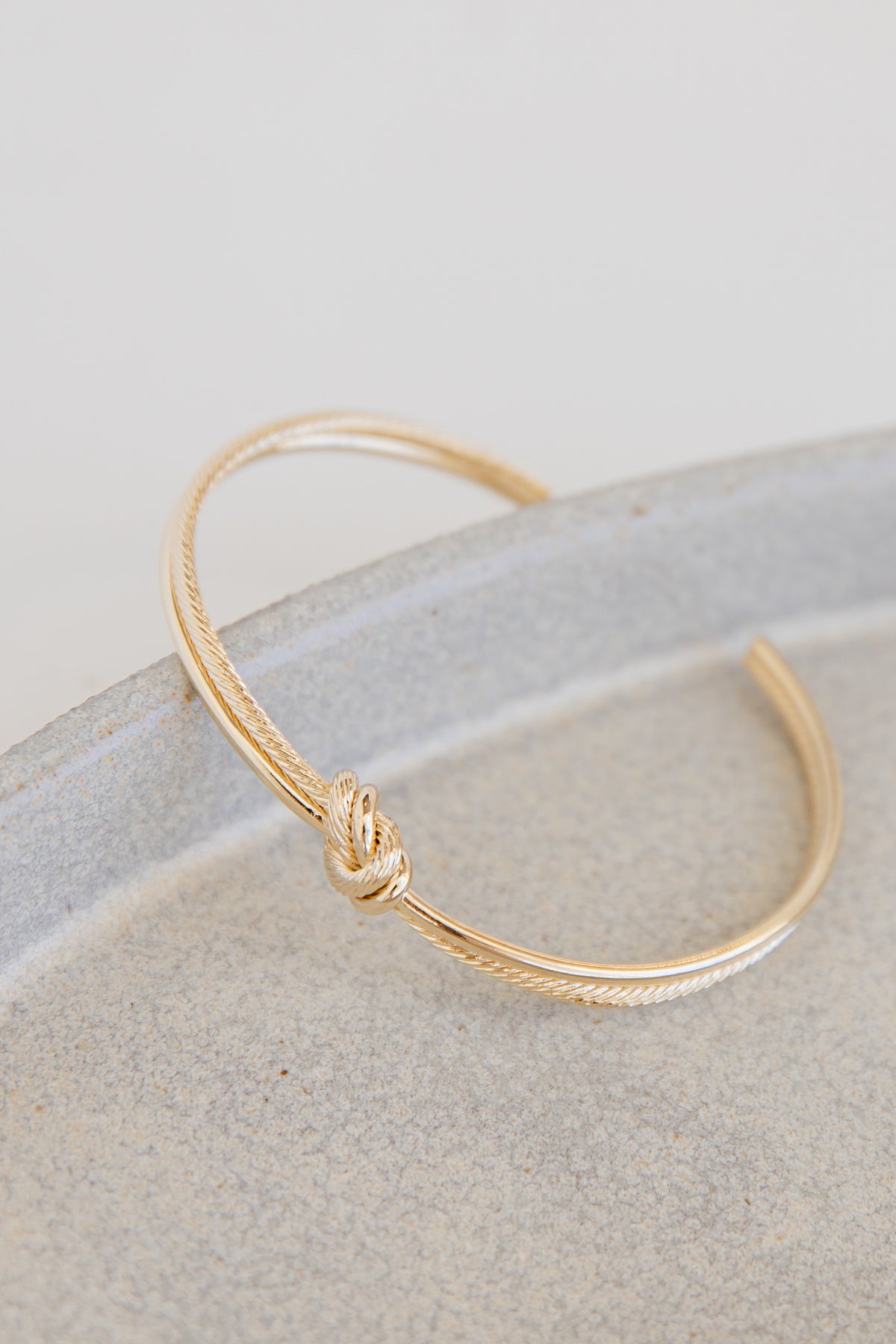 Gold Knot Cuff Bracelet flat lay