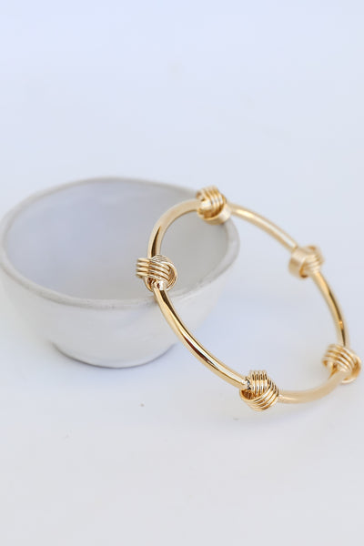 Gold Knot Bracelet flat lay