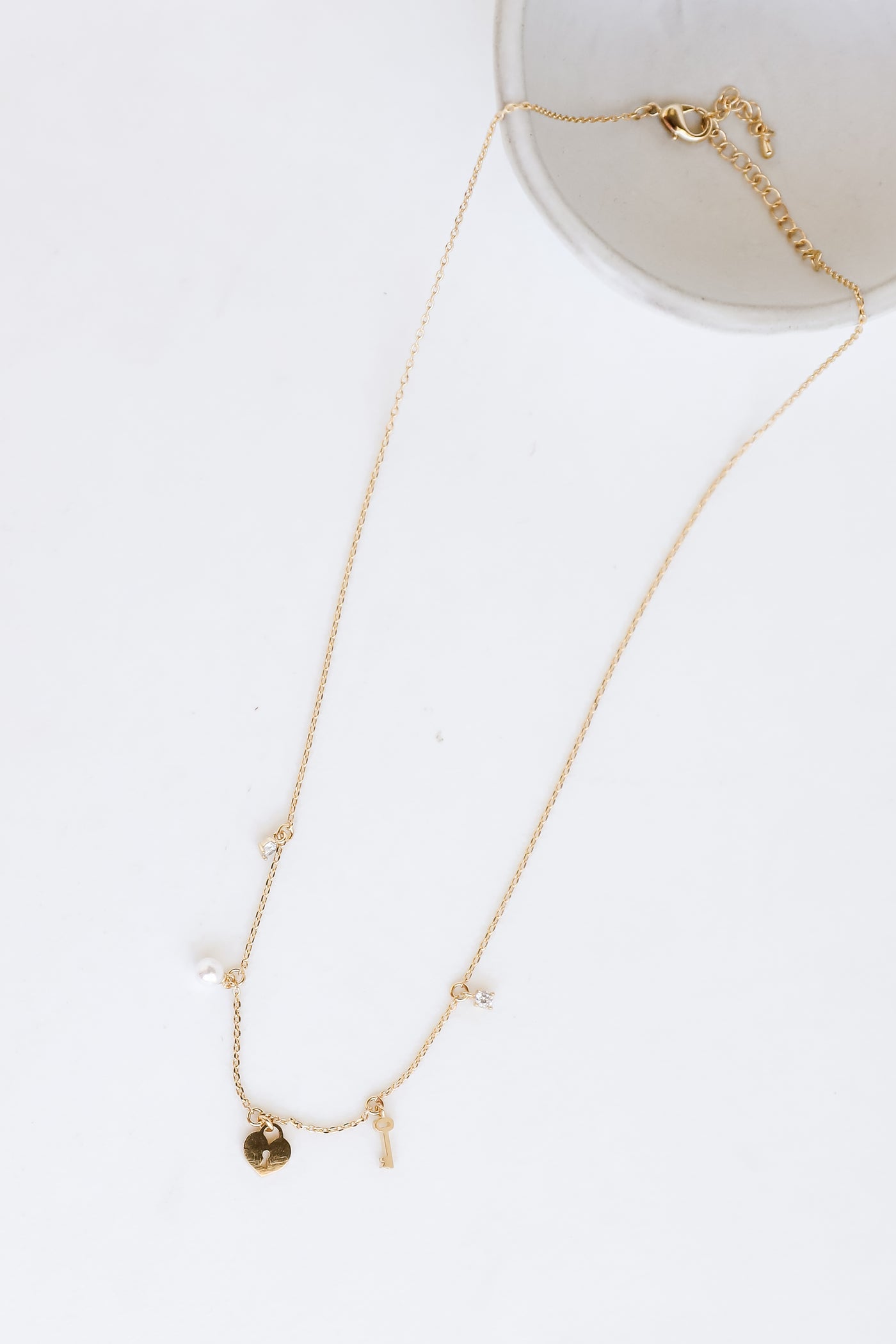 Gold Charm Necklace flat lay