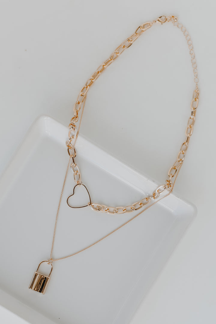 Gold Heart + Lock Layered Necklace flat lay