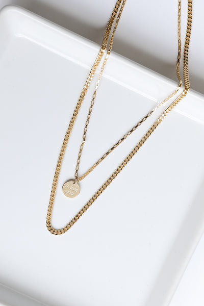 flat lay of a gold necklace
