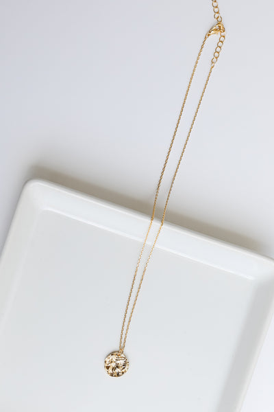 flat lay of gold necklace