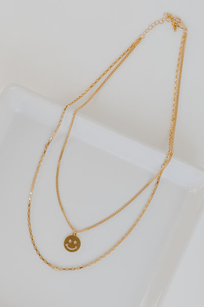 Gold Smiley Face Layered Necklace flat lay