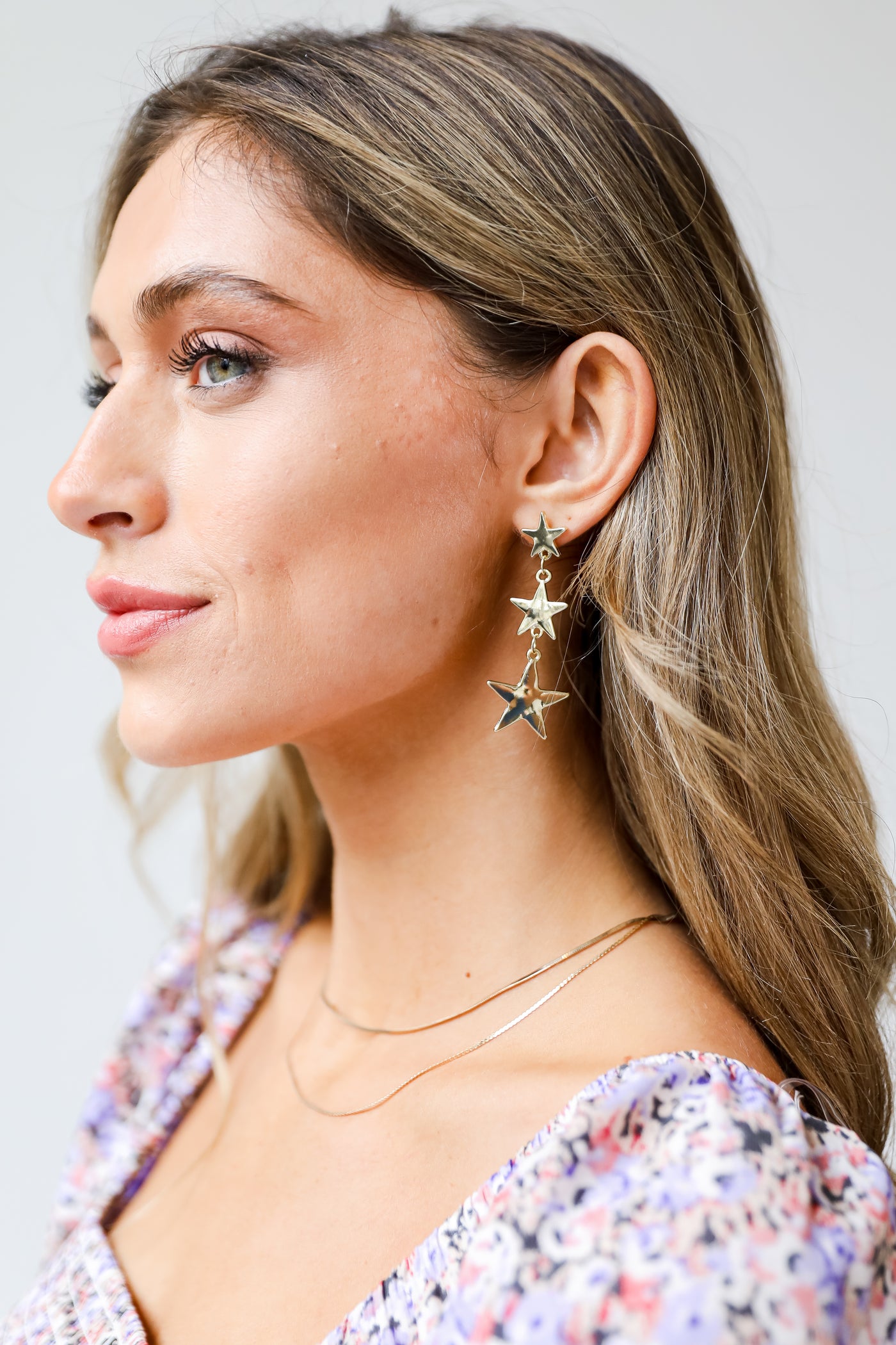 Gold Star Drop Earrings on model