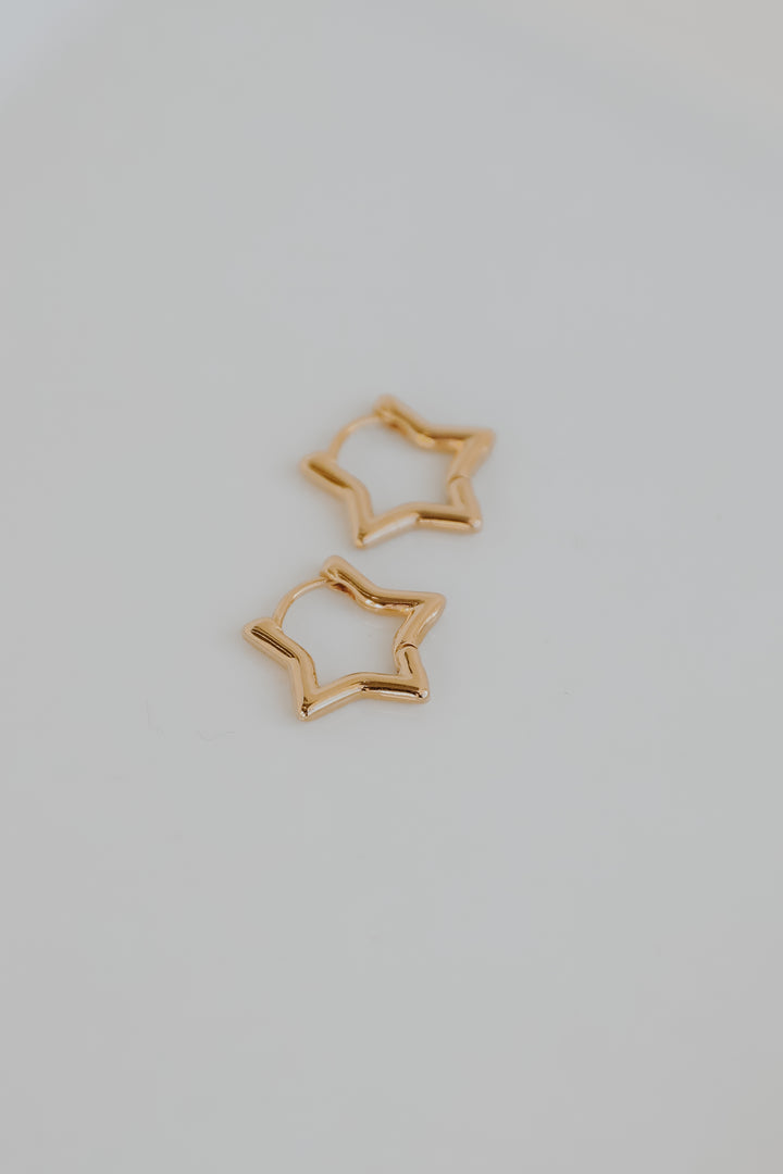 Gold Star Mini Hoop Earrings flat lay