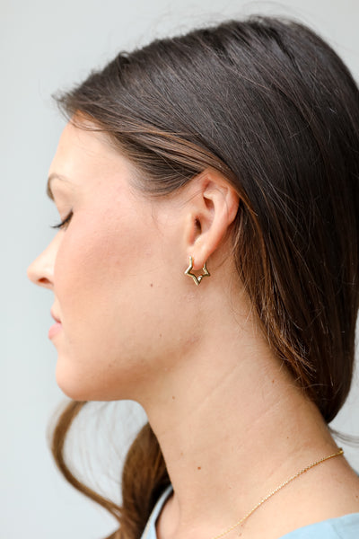 Gold Star Mini Hoop Earrings on model