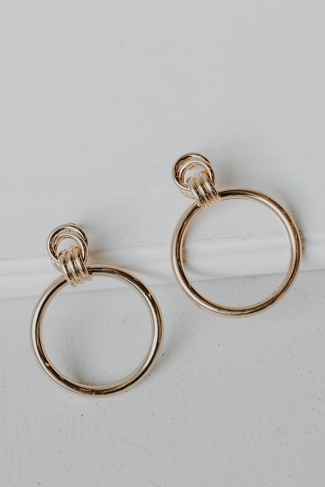 Gold Circle Statement Earrings flat lay