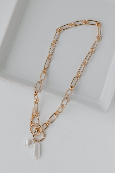 Gold Pearl Necklace flat lay