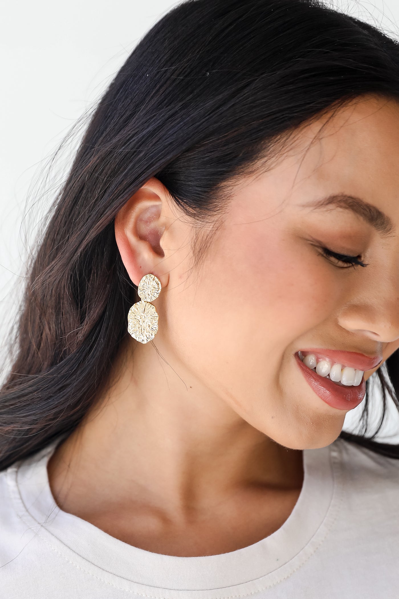 Gold Hammered Drop Earrings on model