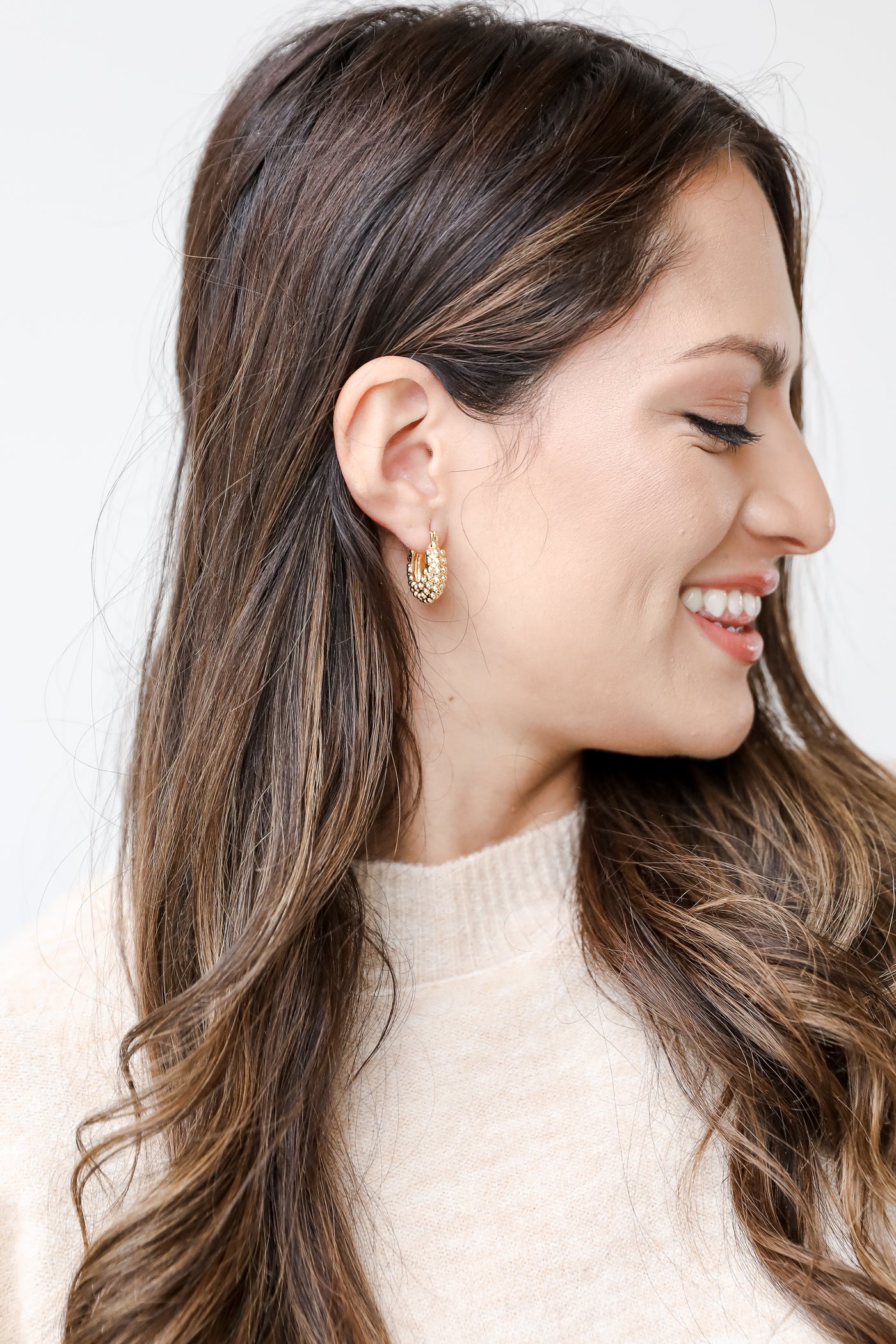 gold textured hoops on model