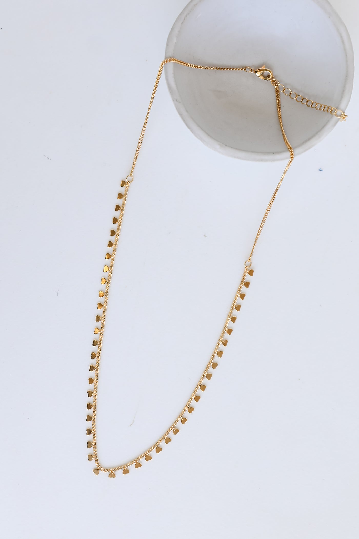 Gold Heart Charm Necklace flat lay