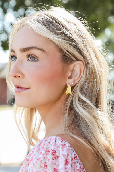 Matte Hoop Earrings in yellow on model