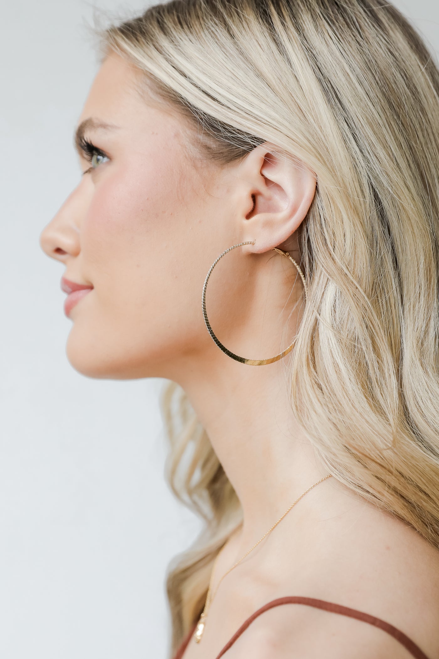 Gold Textured Hoop Earrings on model