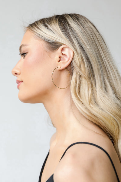 Hammered Hoop Earrings in gold on model
