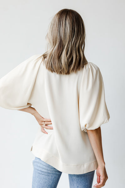 back view of an ivory blouse