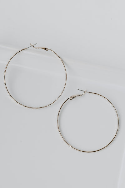 Hammered Hoop Earrings in gold flat lay