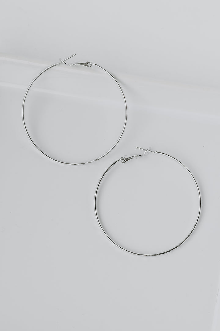 Hammered Hoop Earrings in silver flat lay