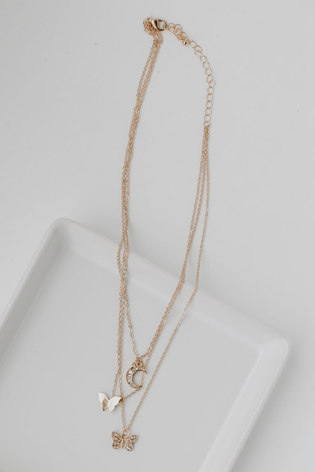 Gold Butterfly + Moon Layered Necklace flat lay