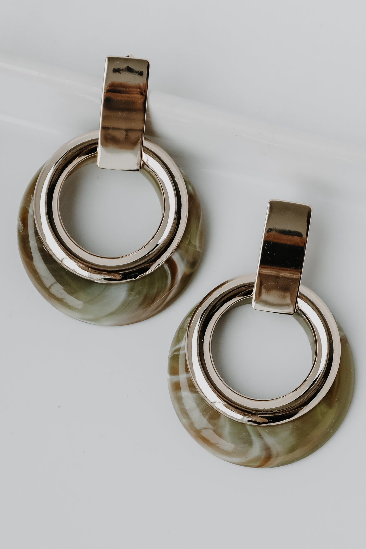Acrylic Statement Earrings in olive flat lay