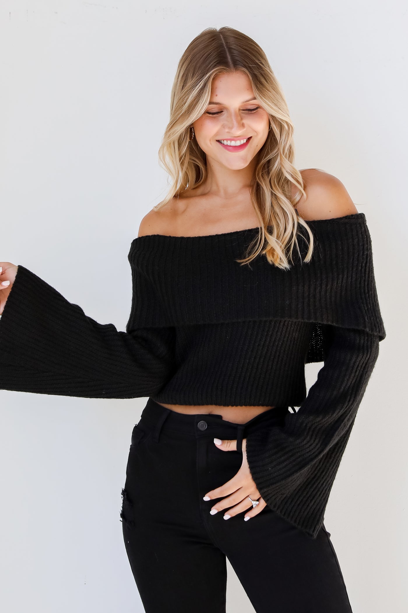 black Off-The-Shoulder Sweater on model