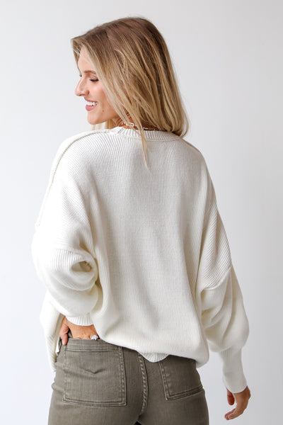 white sweater back view