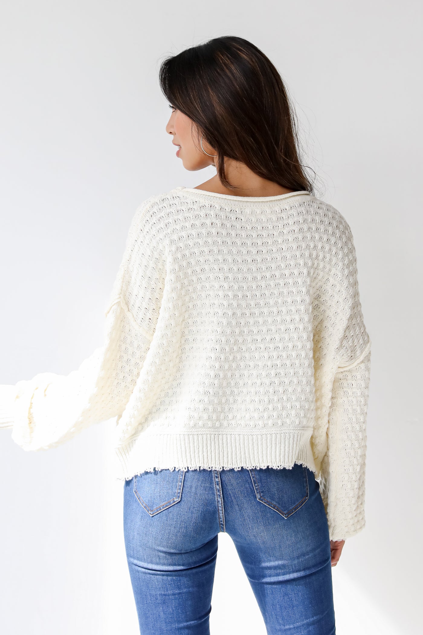 white sweater back view