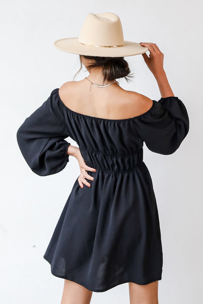 This cute dress is designed with a lightweight textured woven knit. It features an elastic off-the-shoulder neckline, long balloon sleeves with elastic cuffs, and elastic waistband, and a flowy fit that ends at a mini length.