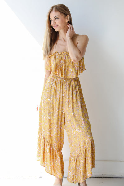 front view of a yellow floral jumpsuit