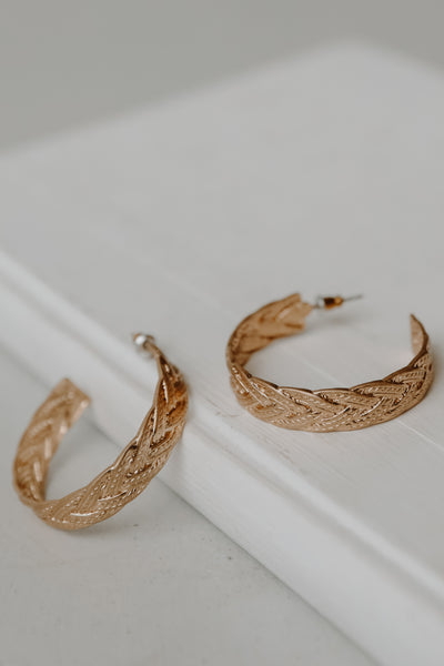 Braided Hoop Earrings in gold flat lay