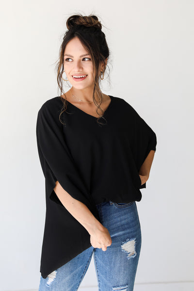 black oversized blouse on model