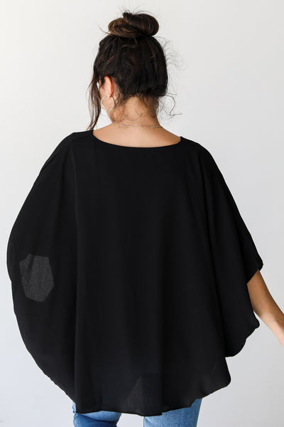 black oversized blouse back view