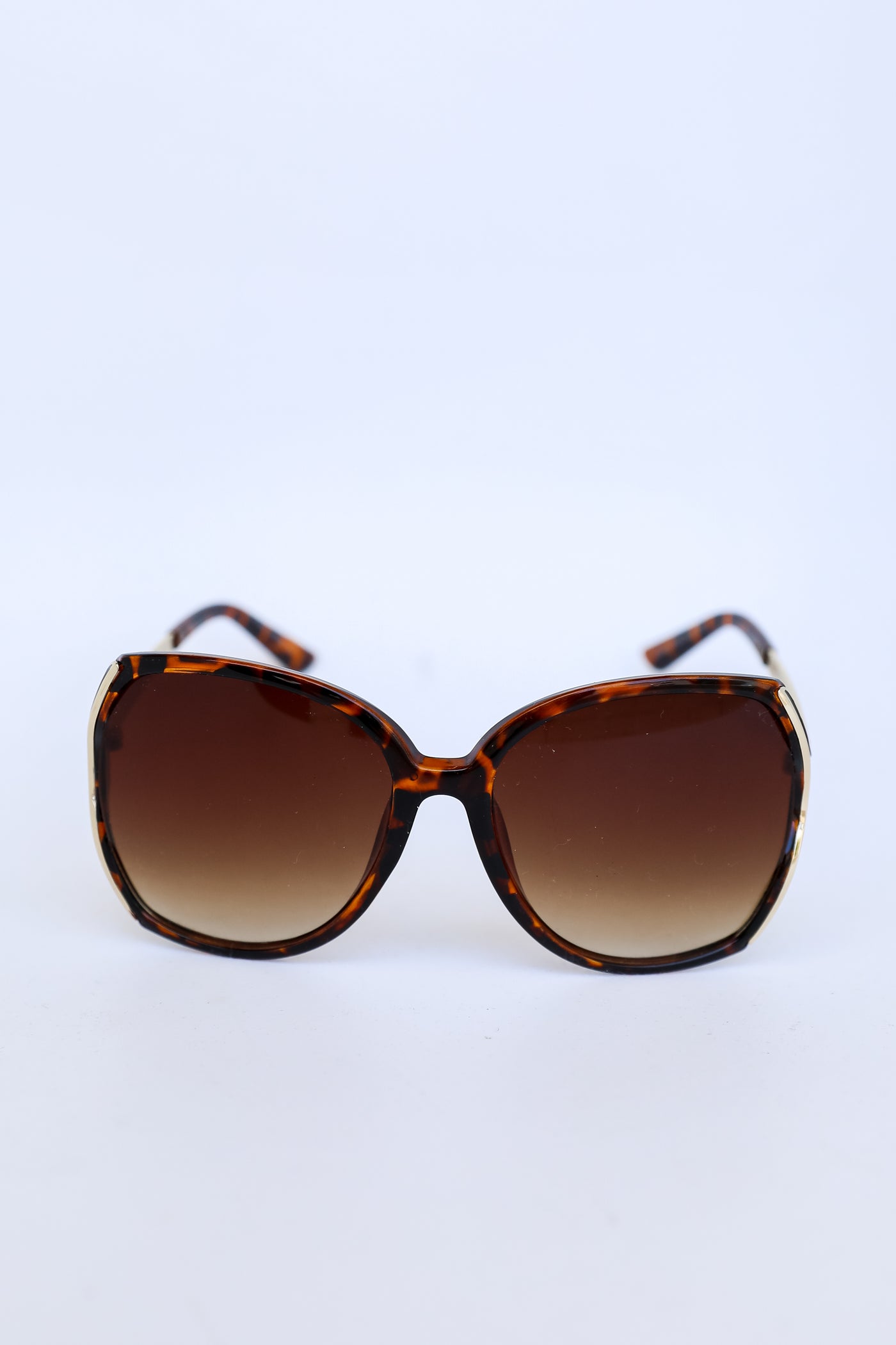 Oversized Sunglasses in tortoise flat lay