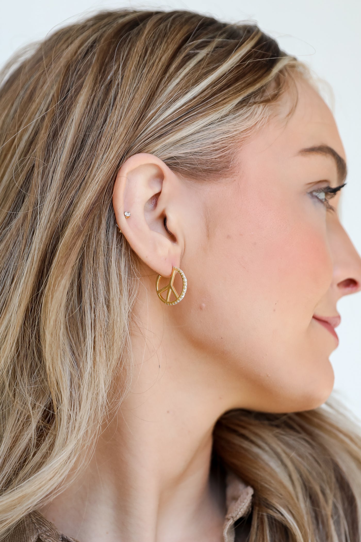 Gold Peace Sign Rhinestone Hoop Earrings on model