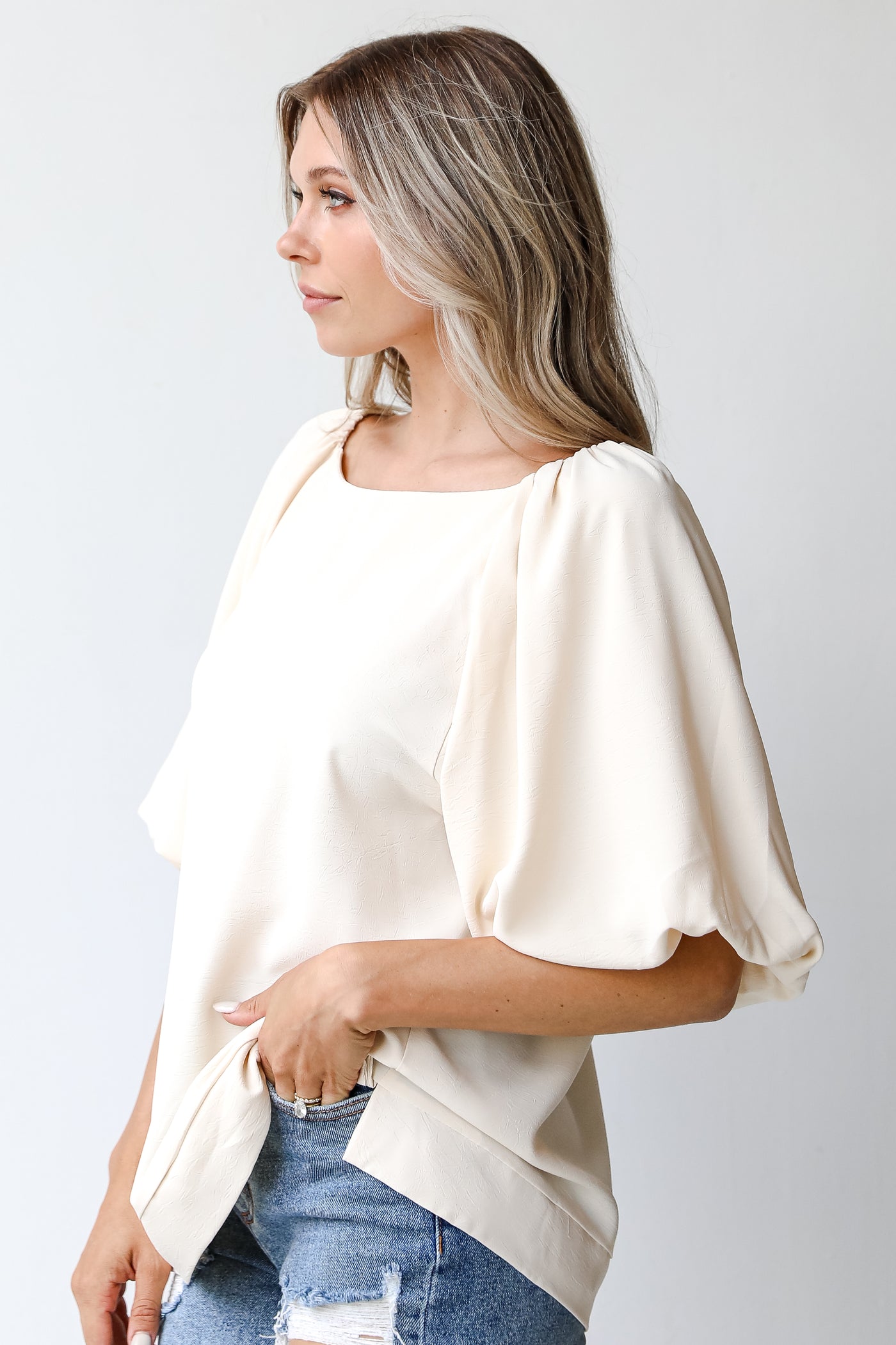 side view of a white puff sleeve blouse