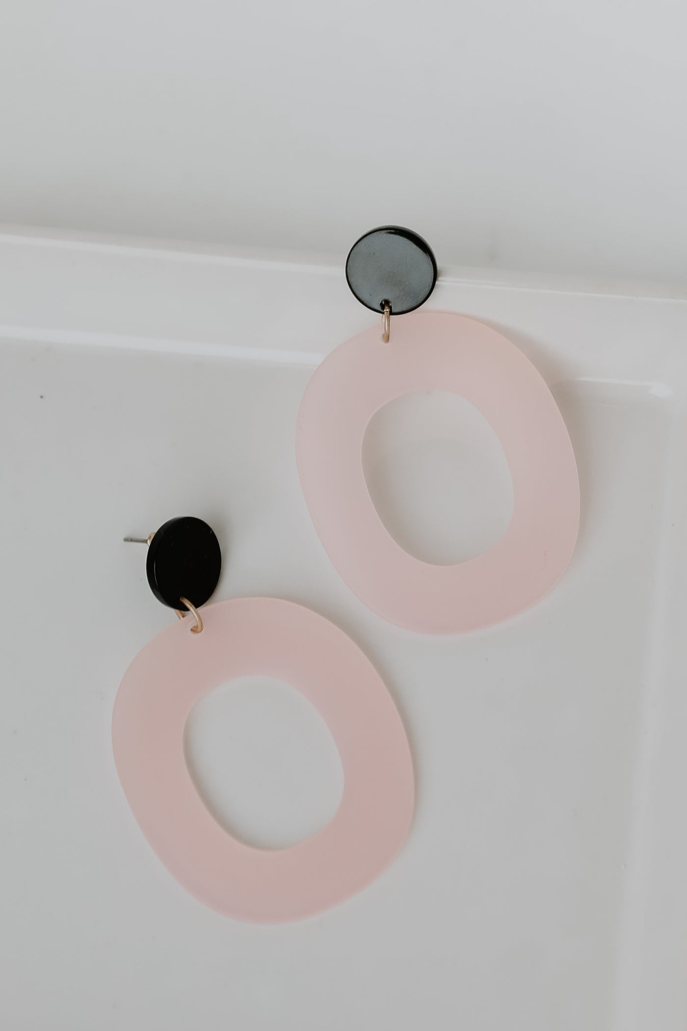 Acrylic Statement Earrings in pink flat lay