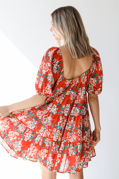 back view of a rust floral mini dress