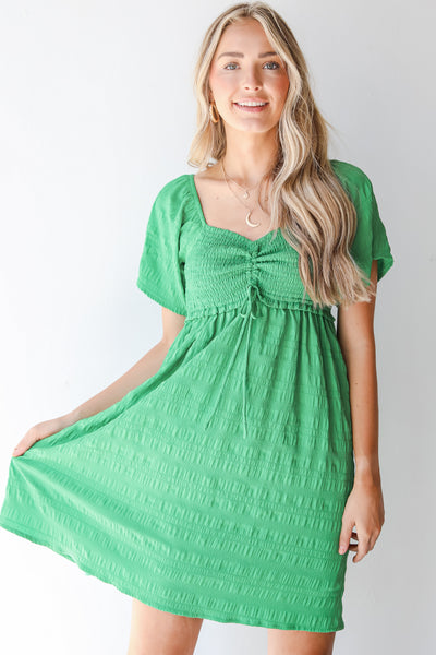 Smocked Mini Dress in green on model