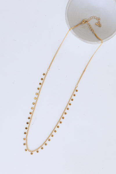 Gold Star Charm Necklace flat lay