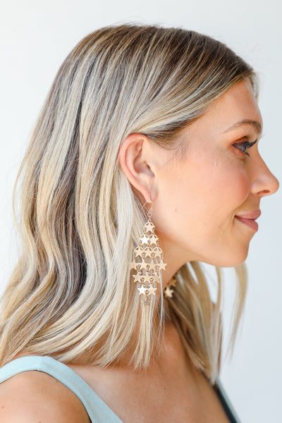 Gold Star Drop Statement Earrings on model
