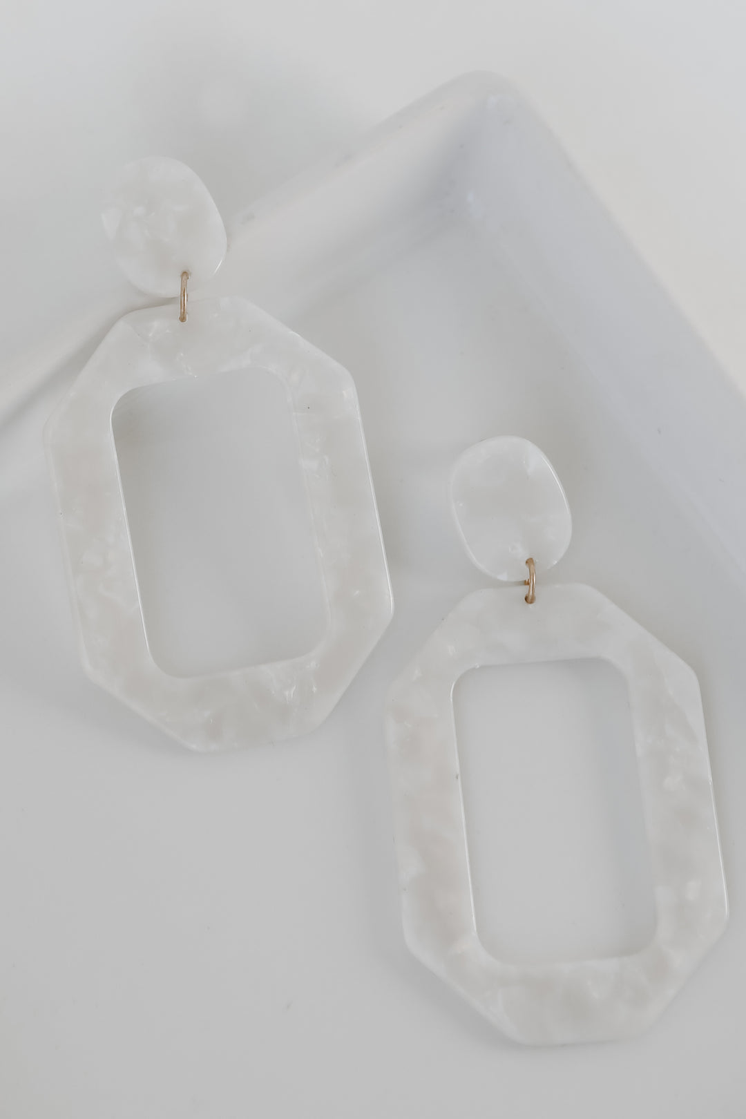 Acrylic Statement Earrings in white flat lay
