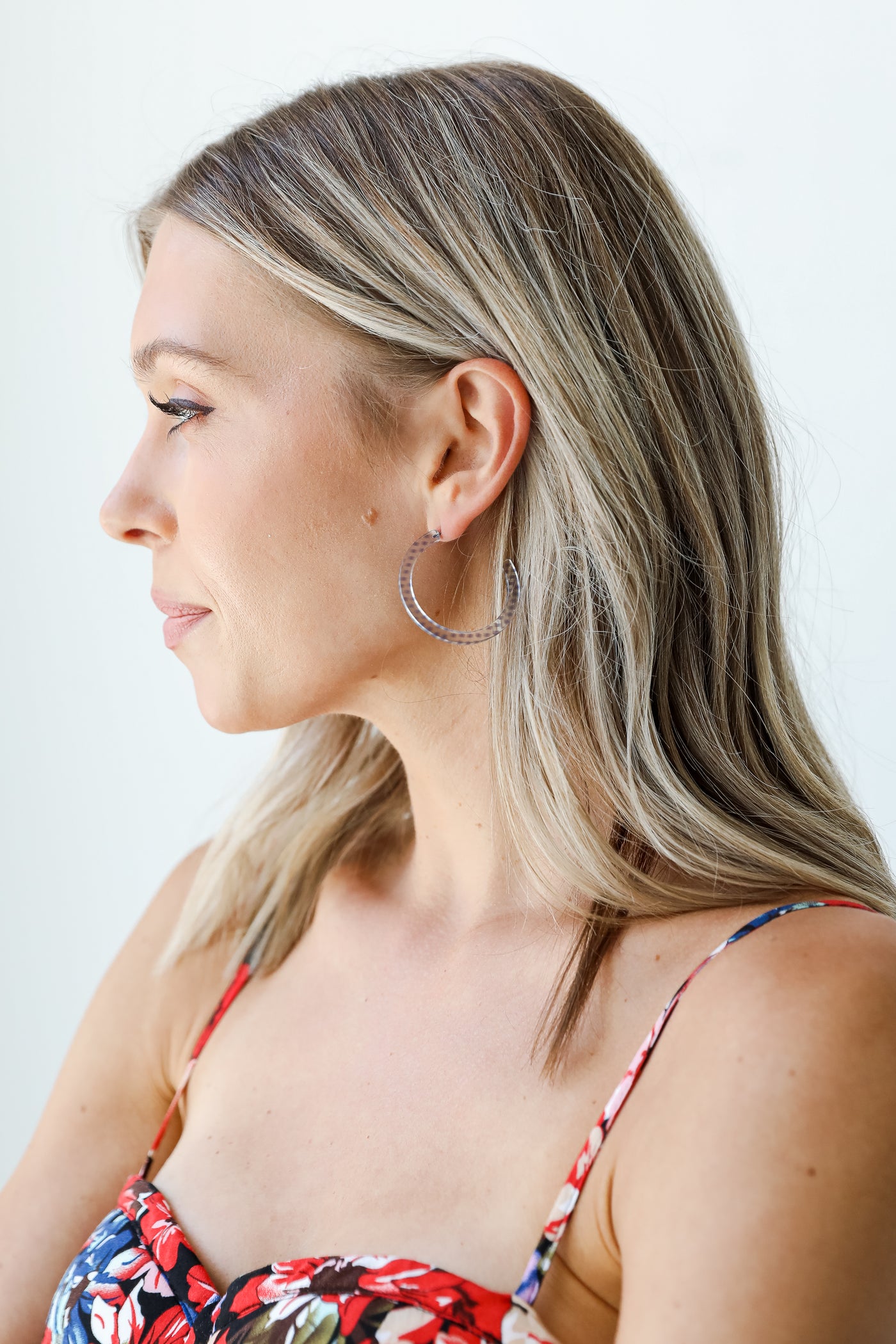 model wearing acrylic hoop earrings
