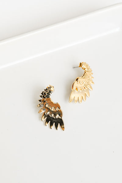 close up of gold wing earrings