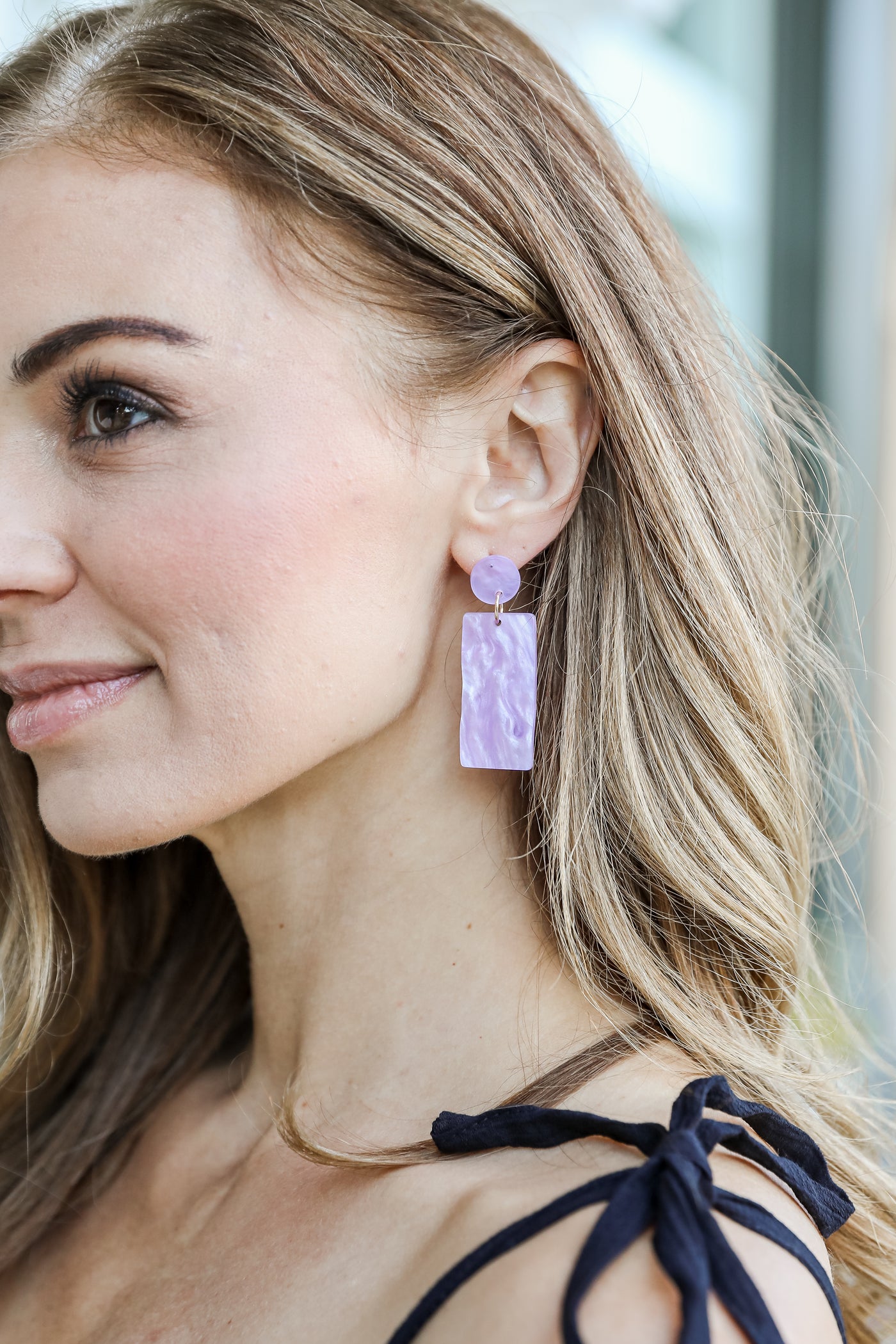 Acrylic Statement Earrings in purple on model