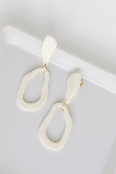 Acrylic Statement Earrings in ivory flat lay