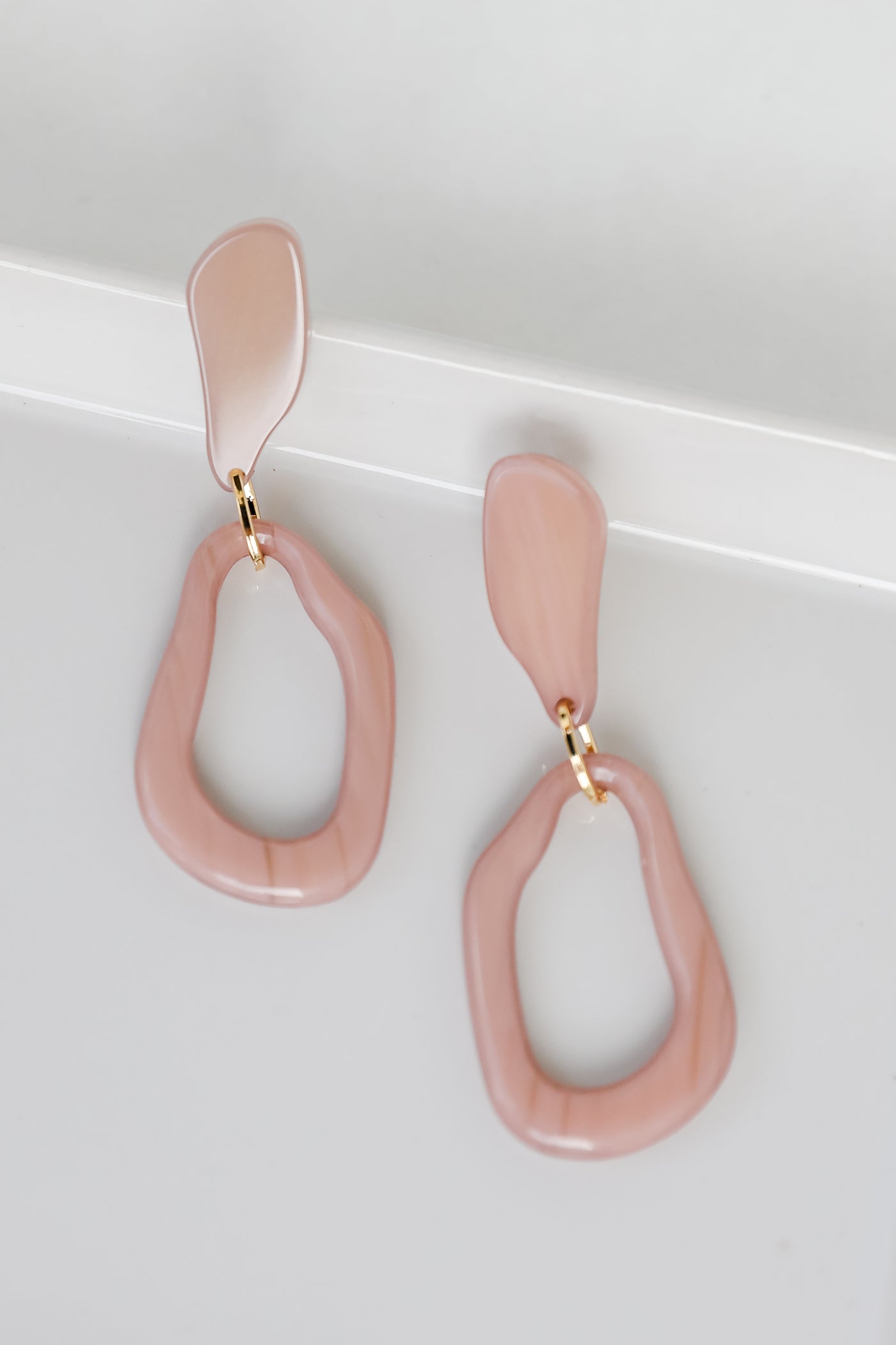 Acrylic Statement Earrings in taupe flat lay
