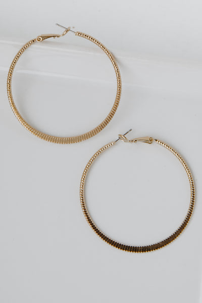 Gold Textured Small Hoop Earrings flat lay