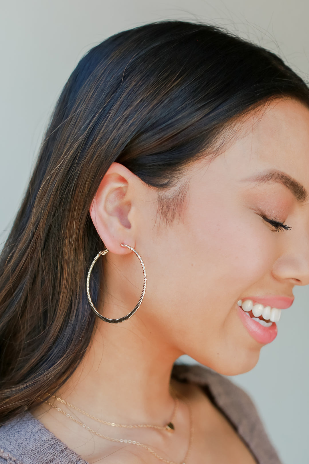 Gold Textured Small Hoop Earrings on model